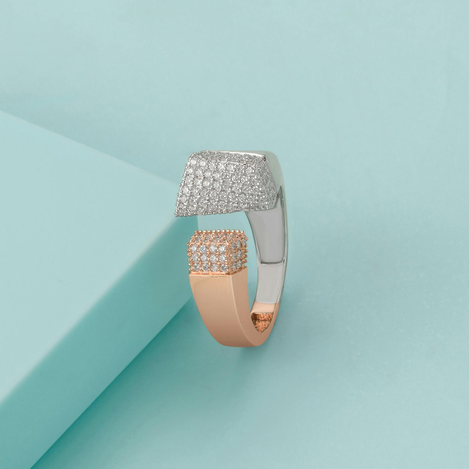 Sophisticated diamond-studded ring featuring rose and white gold on a blue background.